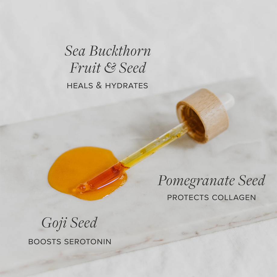 Vegan Omega Glow Drops with organic Seabuckthorn, Goji, and Pomegranate oils on marble surface.