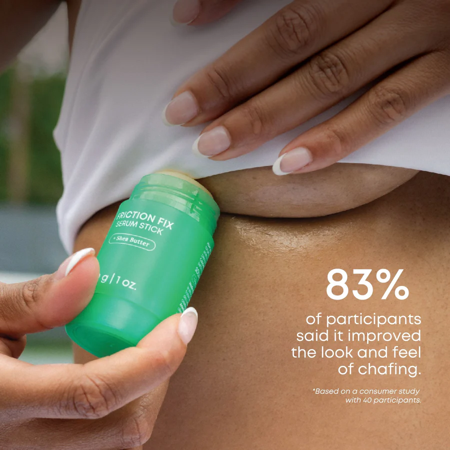 Person applying BushBalm Friction Fix Serum Stick to underarm to prevent chafing and soothe irritation.